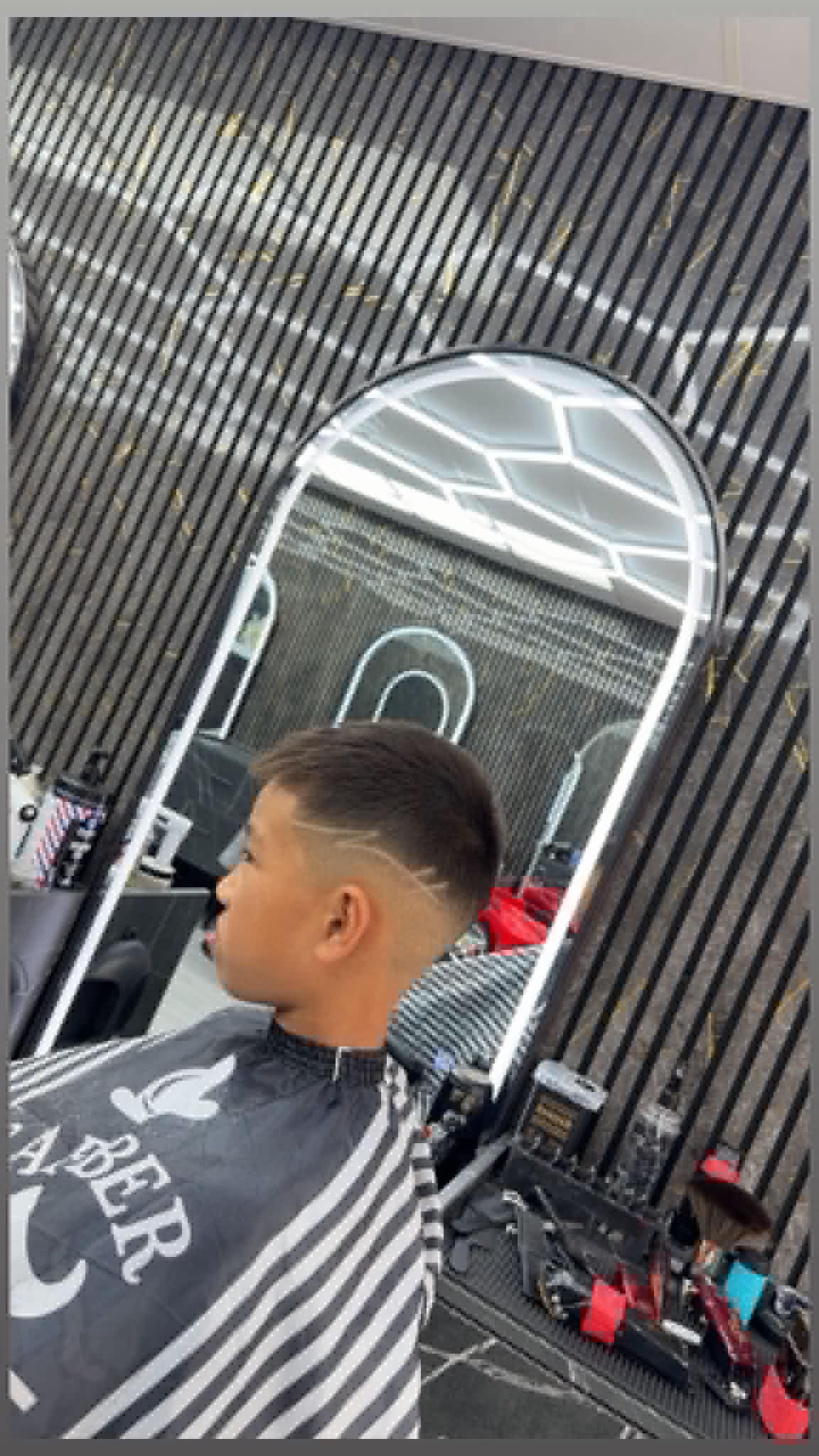 Boys fade haircut with a line design